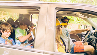 A family with three children going on a road trip in their vehicle