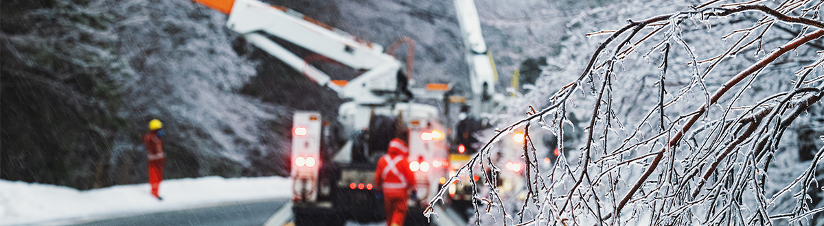 Electrical linemen work to restore power during an intense ice storm.