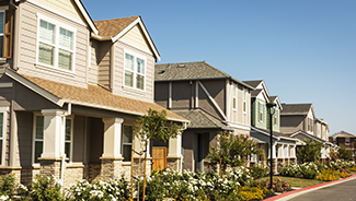 A row of newly built houses in a suburban neighborhood.